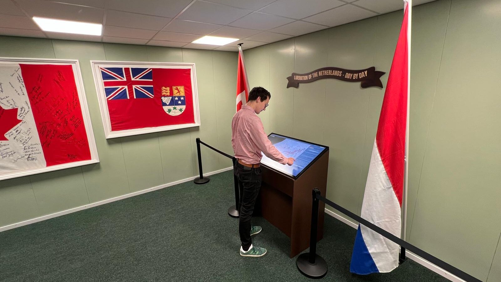 A Frame 44 exhibit installed at Victory Museum Grootegast, with the room and the gallery-screen kiosk visible